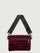 Burgundy suede handbag with a black seat belt strap 