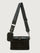 Black quilted crossbody bag with a strap on a light gray background