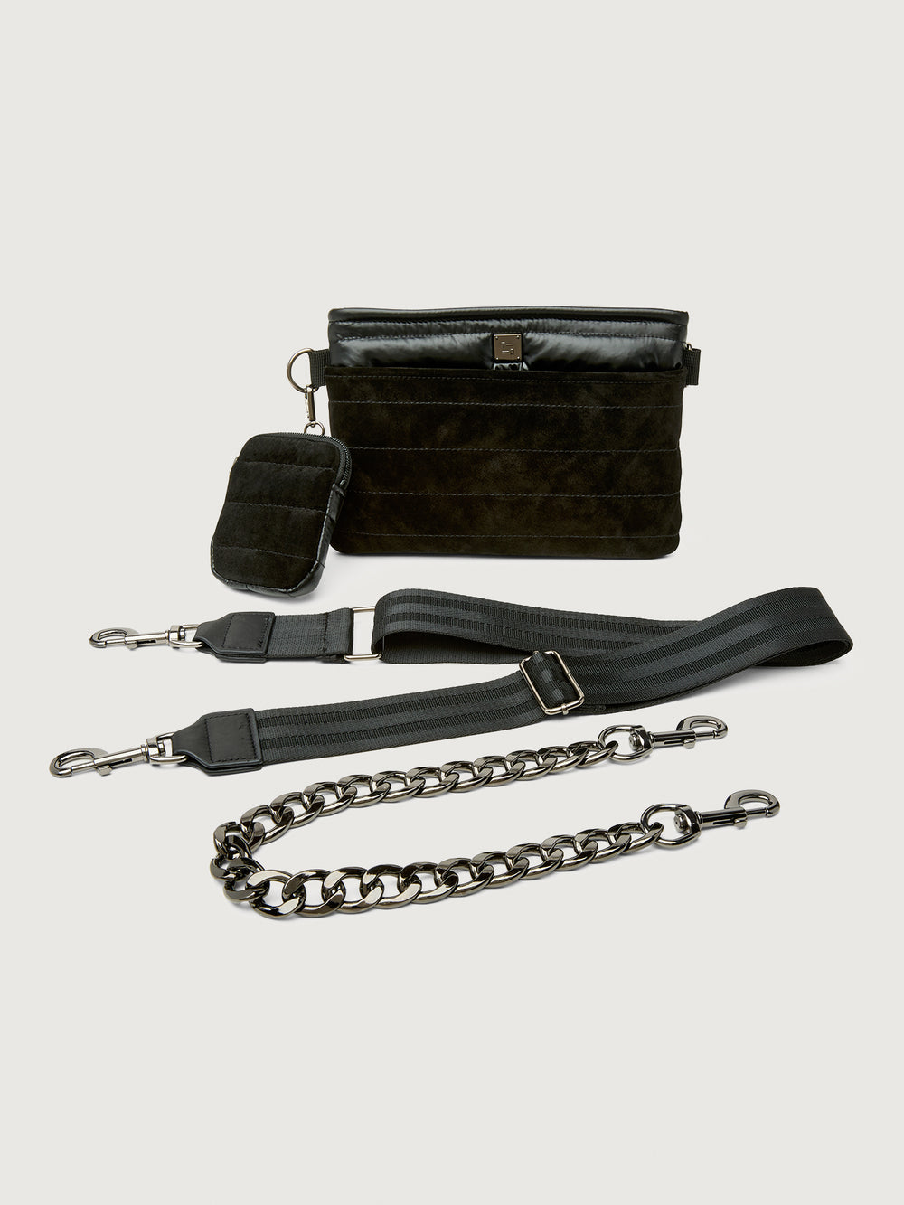 Black leather handbag with detachable chain strap on a light gray background