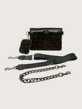 Black leather handbag with detachable chain strap on a light gray background