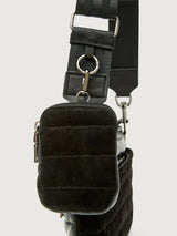 Black crossbody bag with adjustable strap on a light gray background