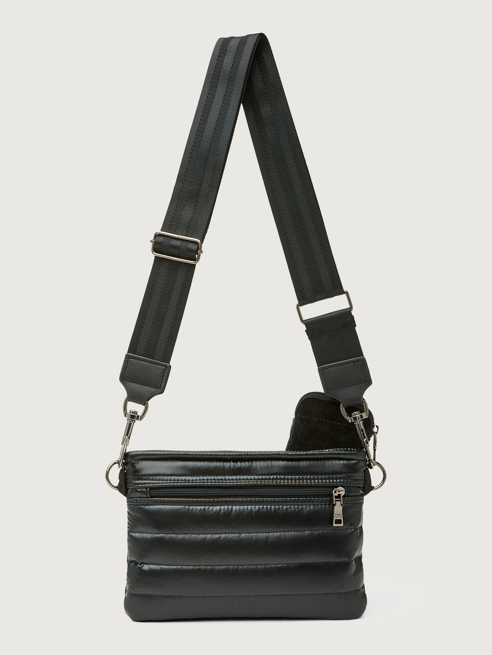 Black leather crossbody bag with a strap on a light gray background