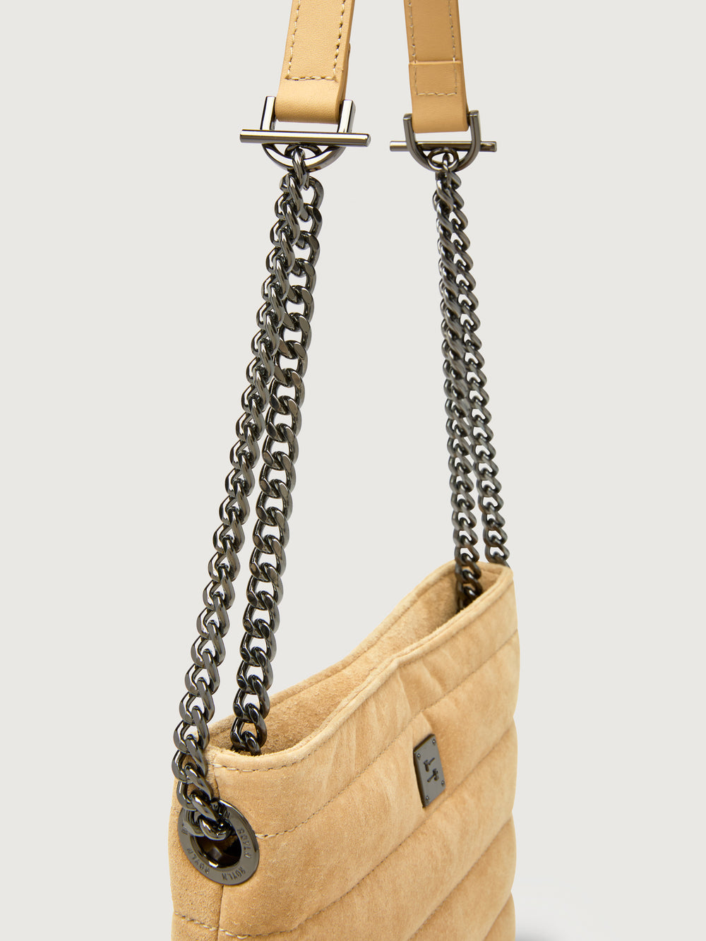 Close up of the Light Beige suede crossbody bag, chain strap detail.