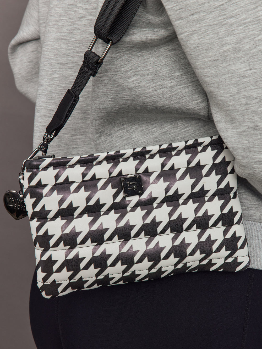 Close-up of Fame Bag Houndstooth Black quilted texture and gunmetal hardware logo.