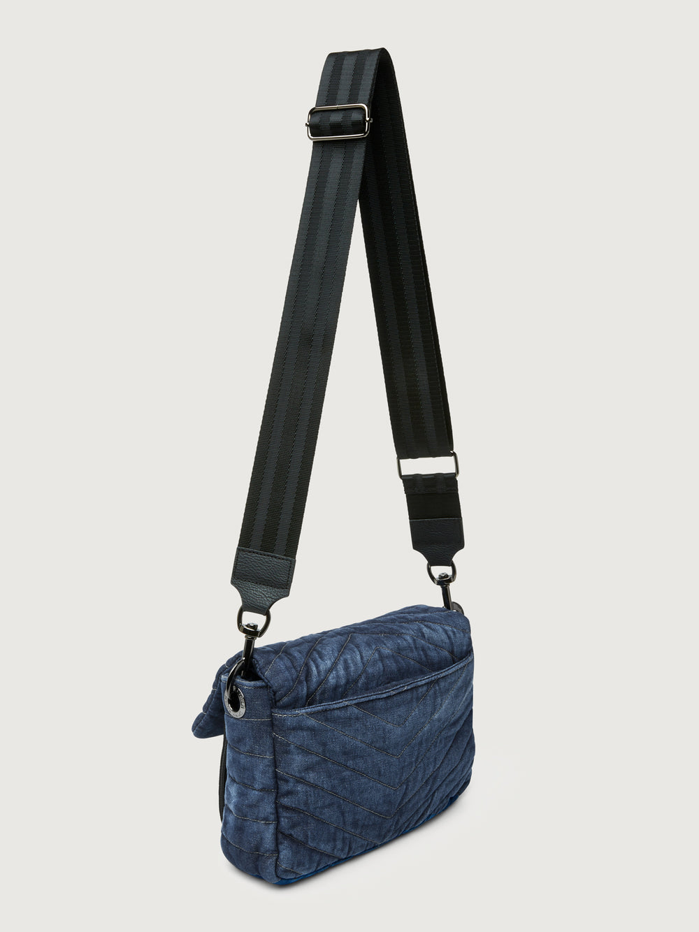 The Muse in Stone Washed Denim, angled back view with long crossbody strap.