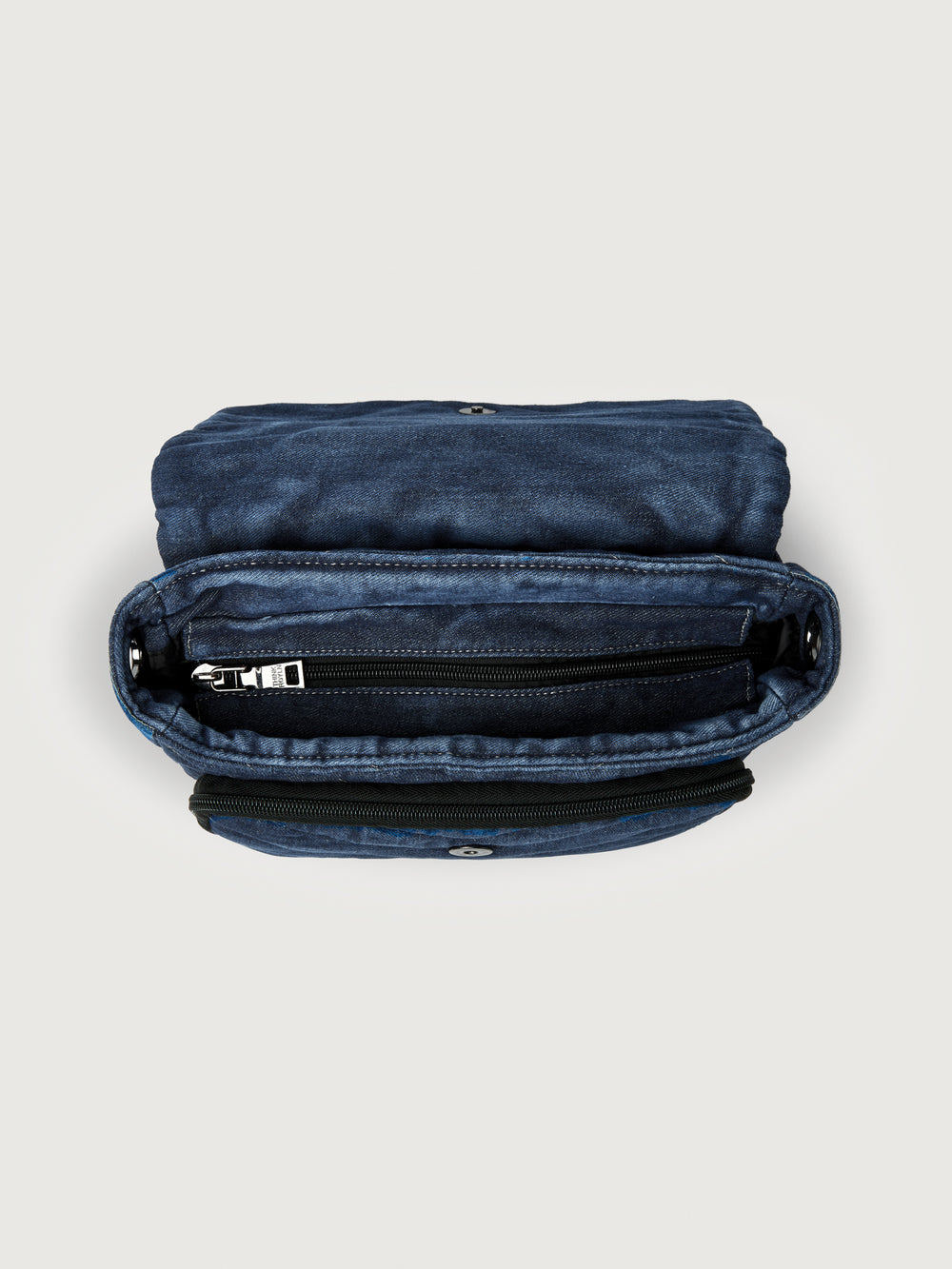 The Muse in Stone Washed Denim, top down view showing zip compartments.