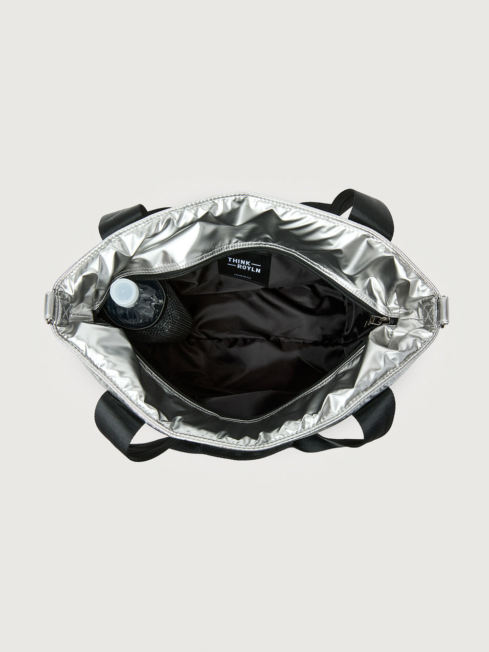 Silver insulated tote bag with black handles on a light gray background