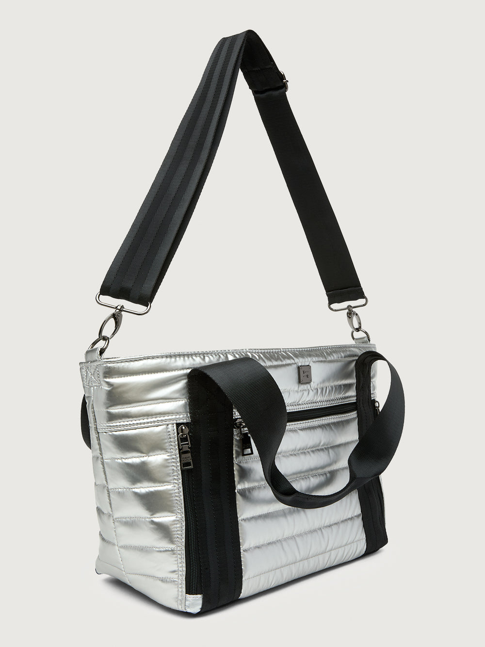 Silver insulated tote bag with black handles on a light gray background