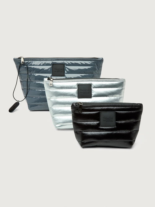 Three zippered pouches in gray, silver, and black on a light gray background