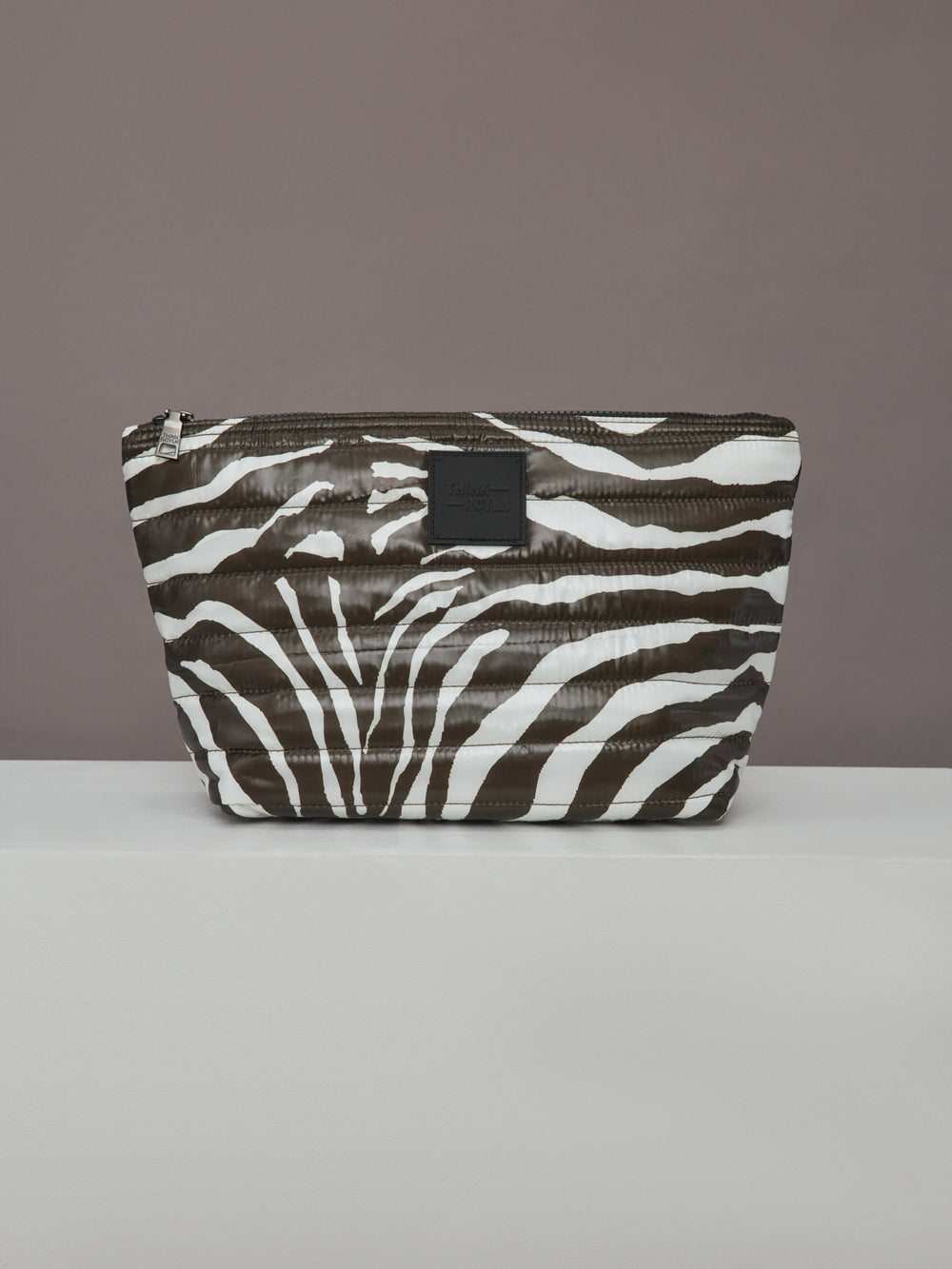 Front view of large zebra-print quilted pouch from the Travel Trio set.