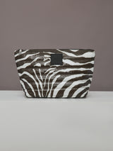 Front view of large zebra-print quilted pouch from the Travel Trio set.
