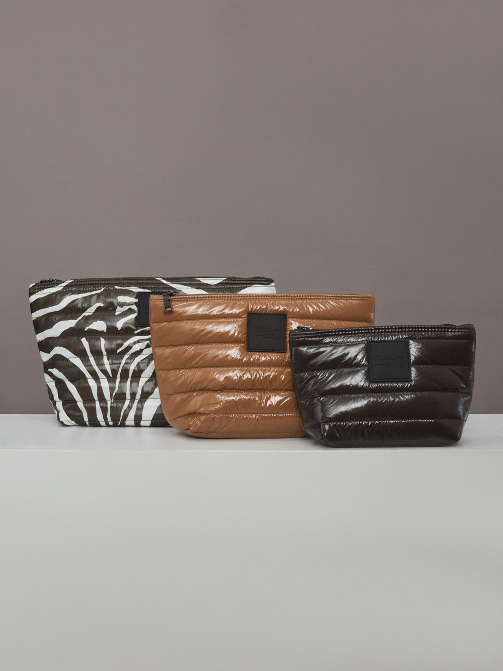 Flat lay of Travel Trio quilted organizer set in Chocolate Zebra Gloss.