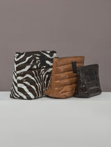 Side view of three-piece Travel Trio pouch set in Chocolate Zebra Gloss.