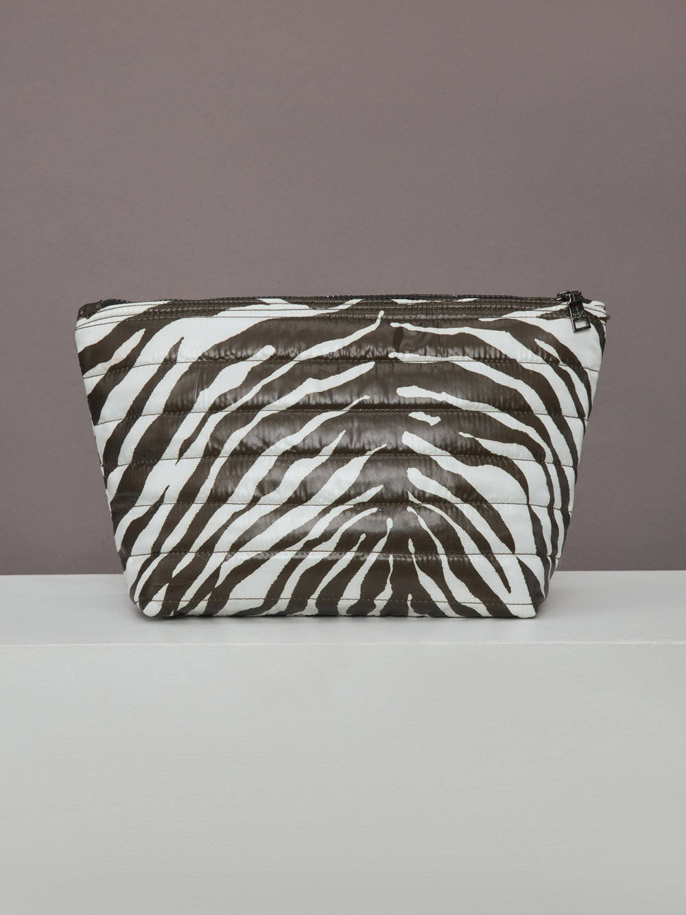 Back view of zebra-print quilted pouch from the Travel Trio set.