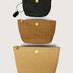 Travel Trio in Dune Raffia, three pouches stacked front view.