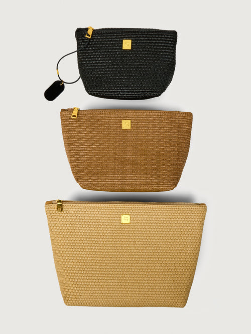 Travel Trio in Dune Raffia, three pouches stacked front view.