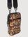 Angled view of leopard print puffer crossbody bag with quilted finish and front zipper.