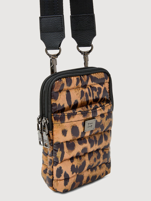 Angled view of leopard print puffer crossbody bag with quilted finish and front zipper.