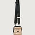 Gold crossbody bag with a black strap on a light gray background