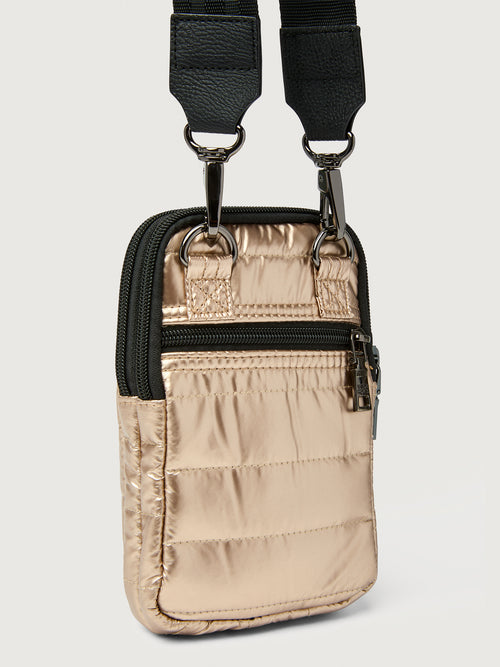 Beige pouch with black strap on a light gray background