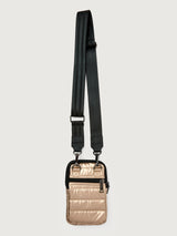 Gold crossbody bag with a black strap on a light gray background