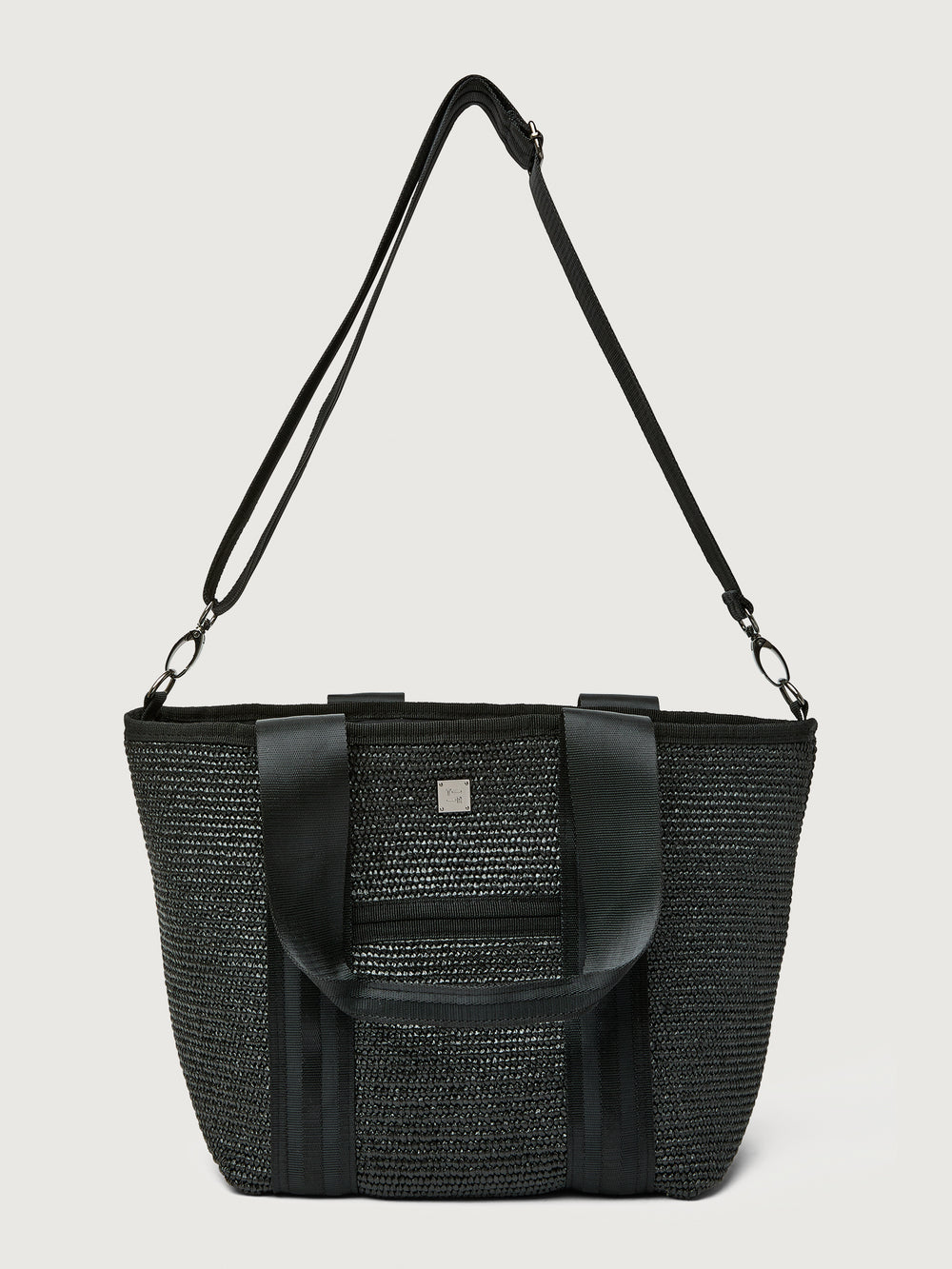 Back view of Think Royln Capri tote in black with long crossbody strap attached.