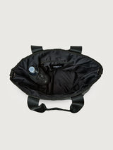 Interior view of Think Royln Capri black tote showing spacious lining, zip pocket, and side bottle holder.