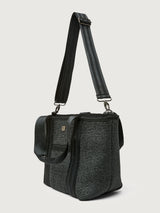 Three-quarter back view of Think Royln Capri tote in black with wide crossbody strap.