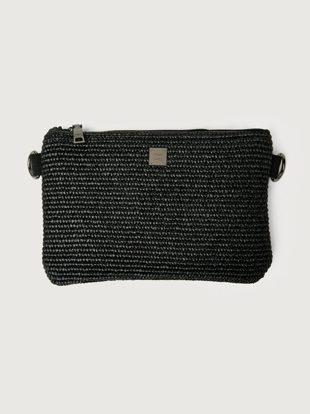 Flat lay of Think Royln Capri detachable black pouch with zipper closure and metal logo plate.