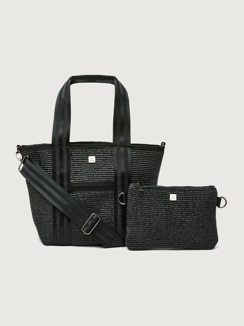 Front view of Think Royln Capri tote bag in black with matching detachable pouch and adjustable shoulder strap.