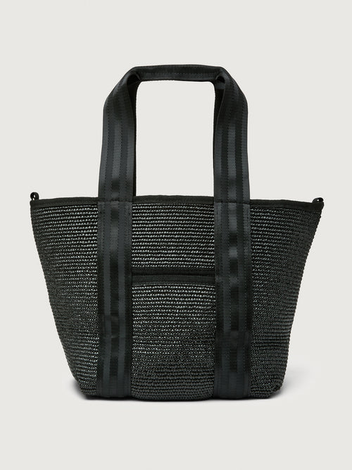 Back view of Think Royln Capri black woven tote highlighting striped handles.