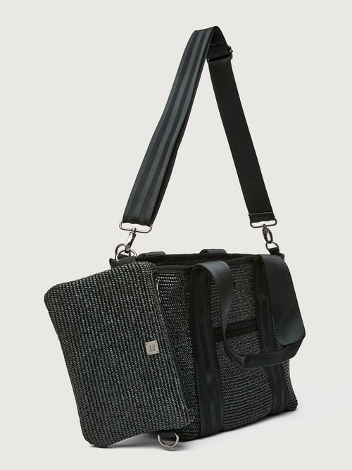 Side angle of Think Royln Capri tote with detachable black pouch clipped to bag.