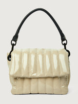 Beige handbag with black handle on a light gray background