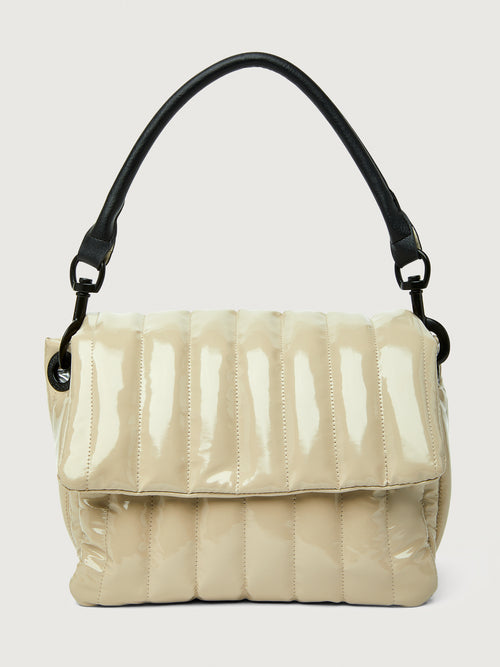 Beige handbag with black handle on a light gray background