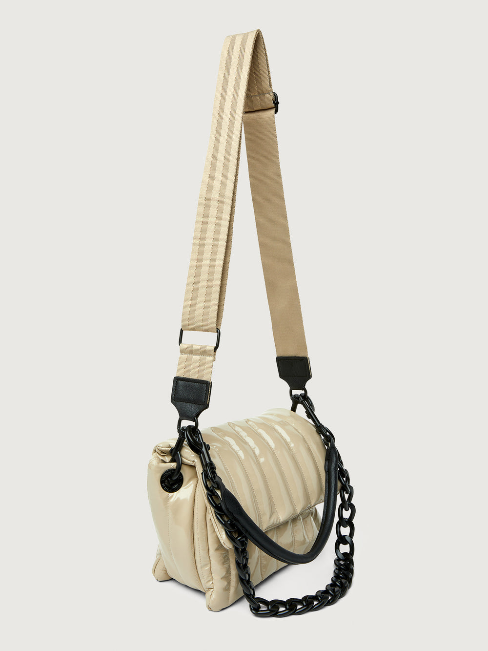 Beige handbag with black handle on a light gray background