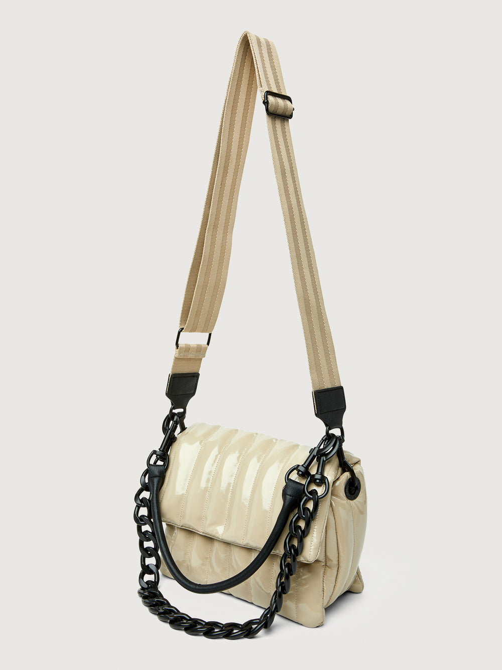 Beige handbag with black handle on a light gray background