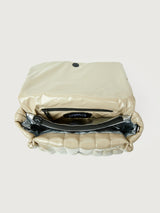 Beige handbag with black handle on a light gray background