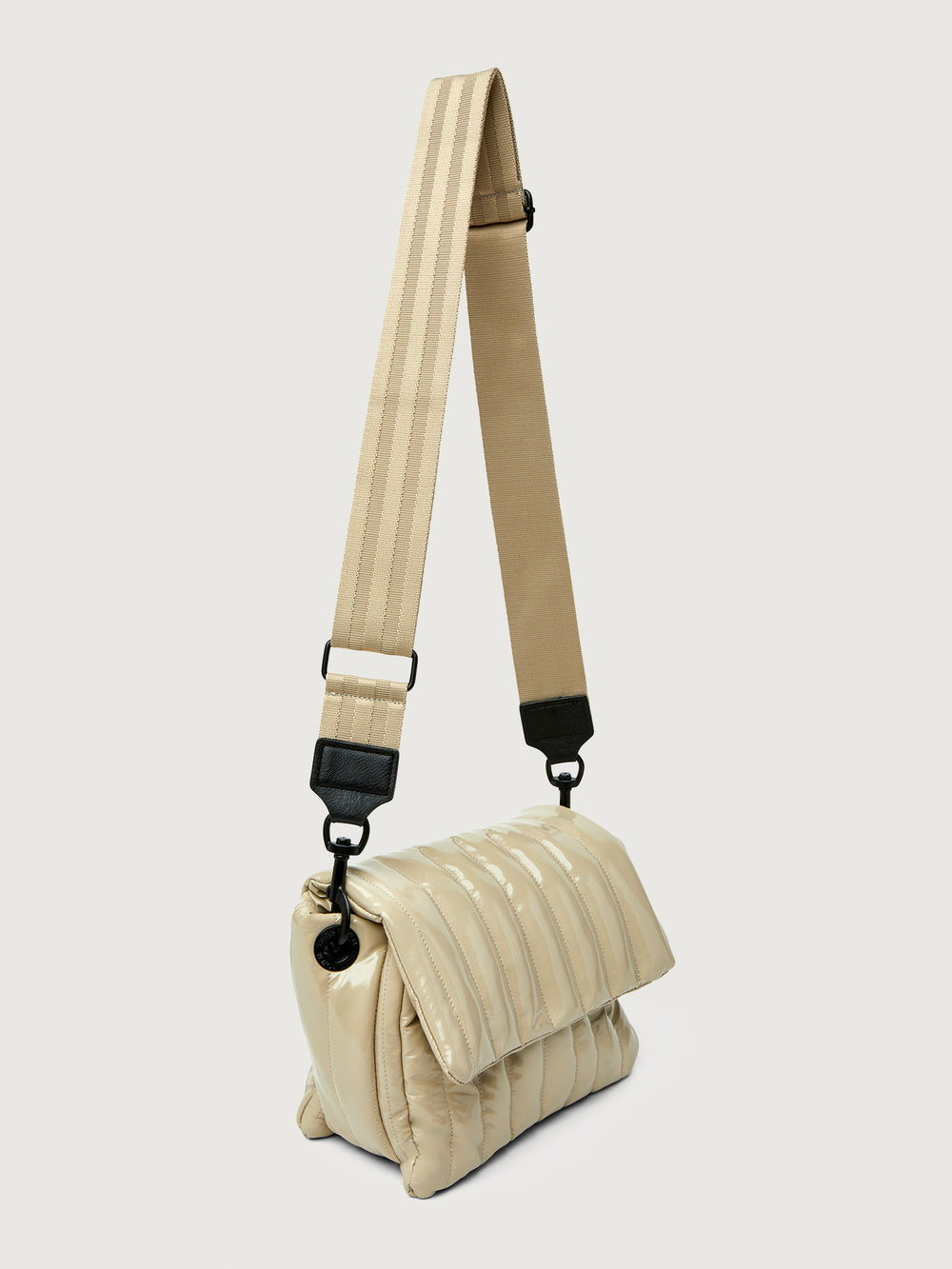 Beige handbag with black handle on a light gray background