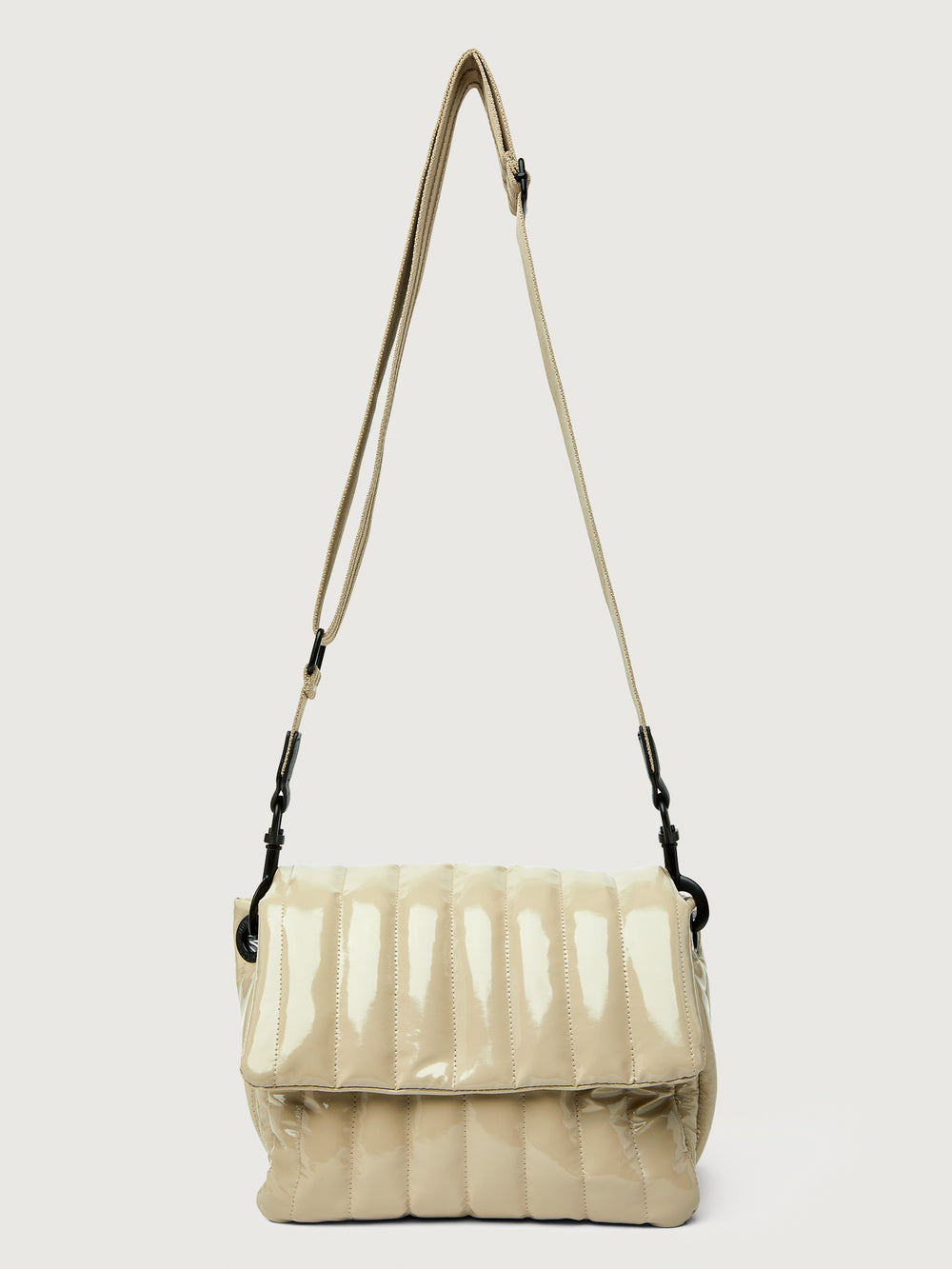 Beige handbag with black handle on a light gray background