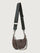 Brown handbag with a black strap and chain detail on a light gray background