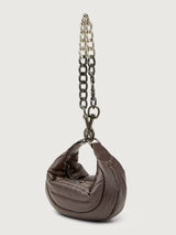 Small brown handbag with a chain detail on a light gray background