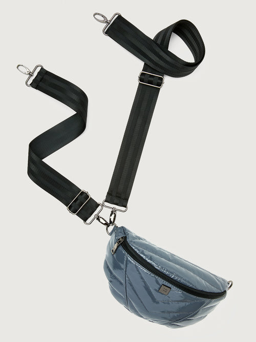 Carbon waist bag with a black strap on a light gray background