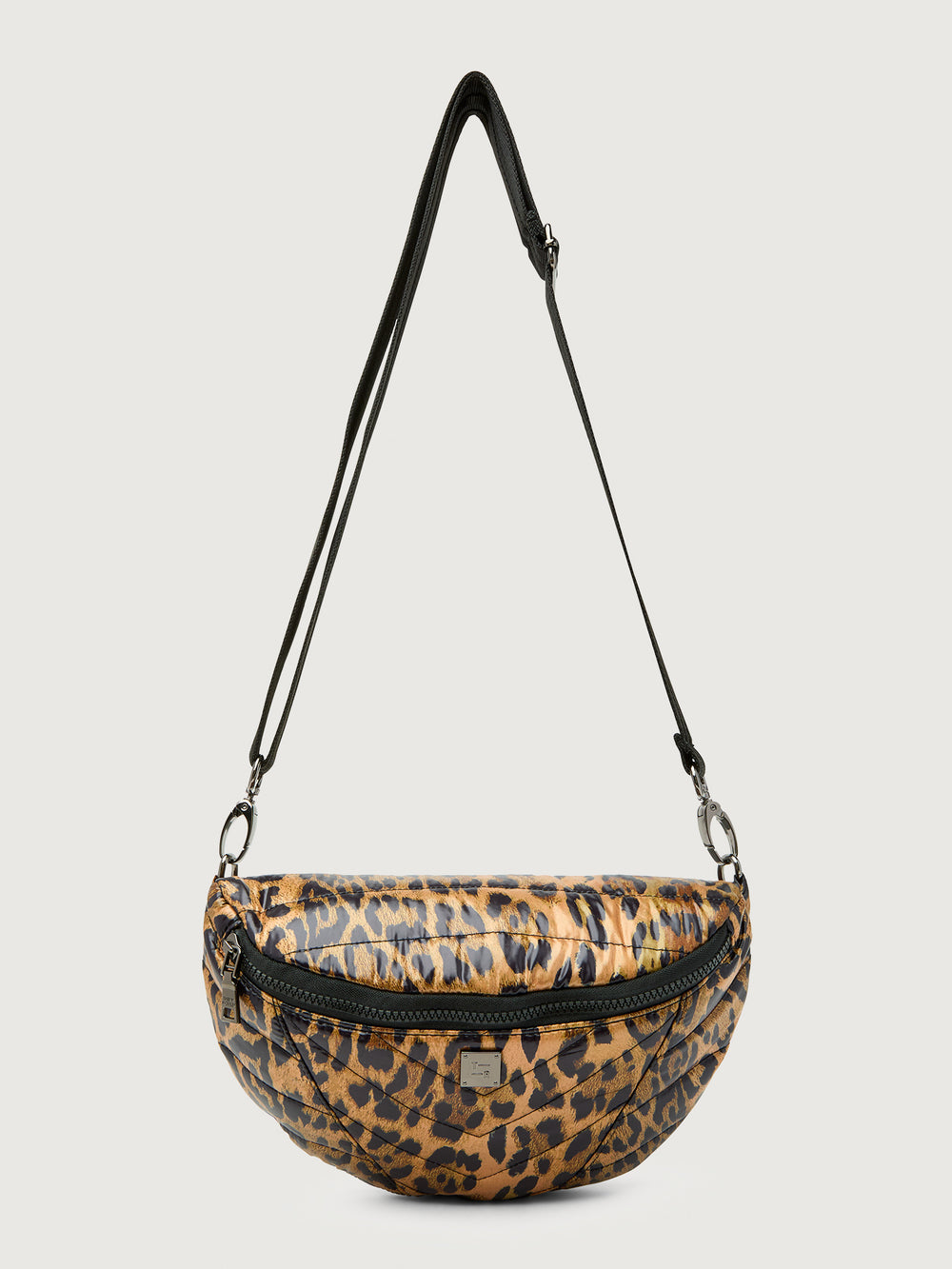 Leopard print crossbody bag with a black strap on a light gray background