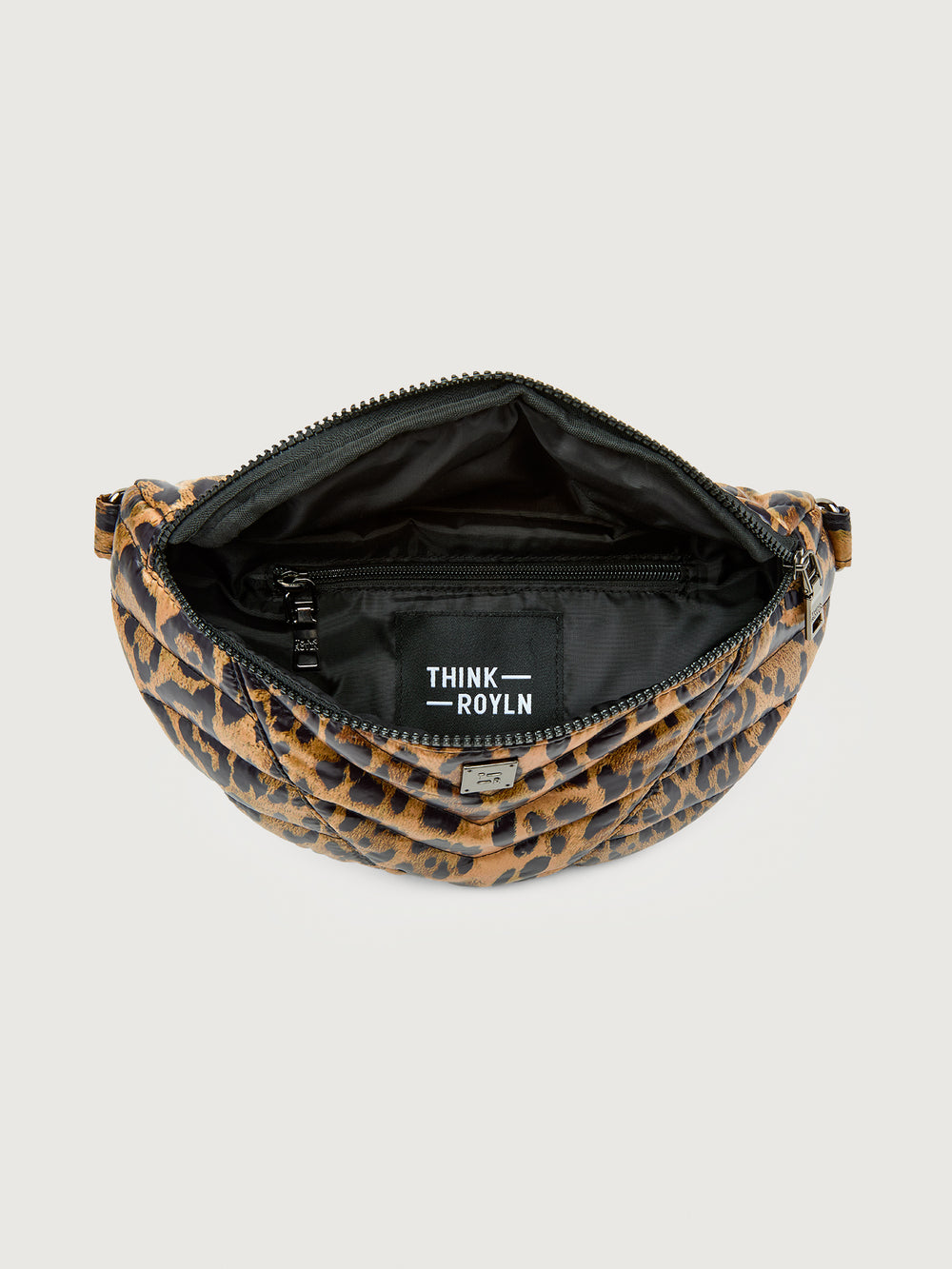 Leopard print crossbody bag with a black strap on a light gray background