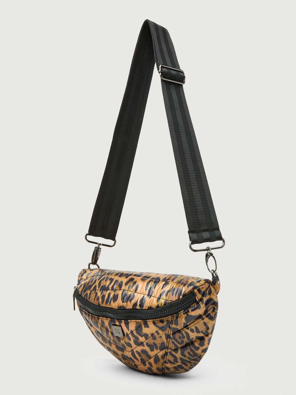 Leopard print crossbody bag with a black strap on a light gray background
