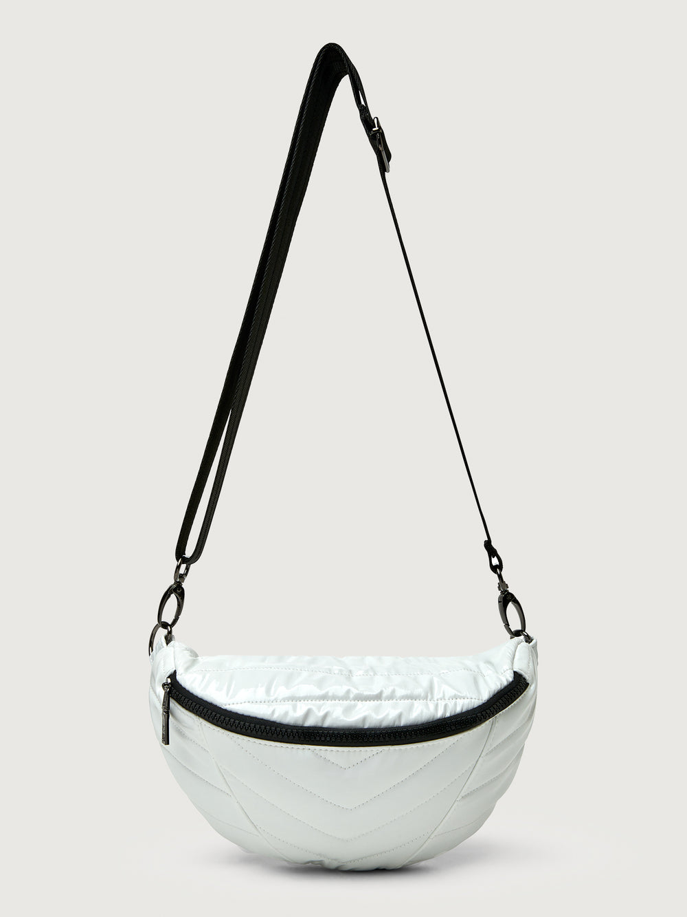 White patent leather bag with black hardware, featuring a half moon shape.