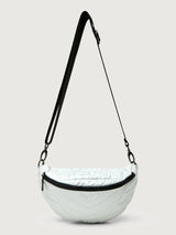 White patent leather bag with black hardware, featuring a half moon shape.