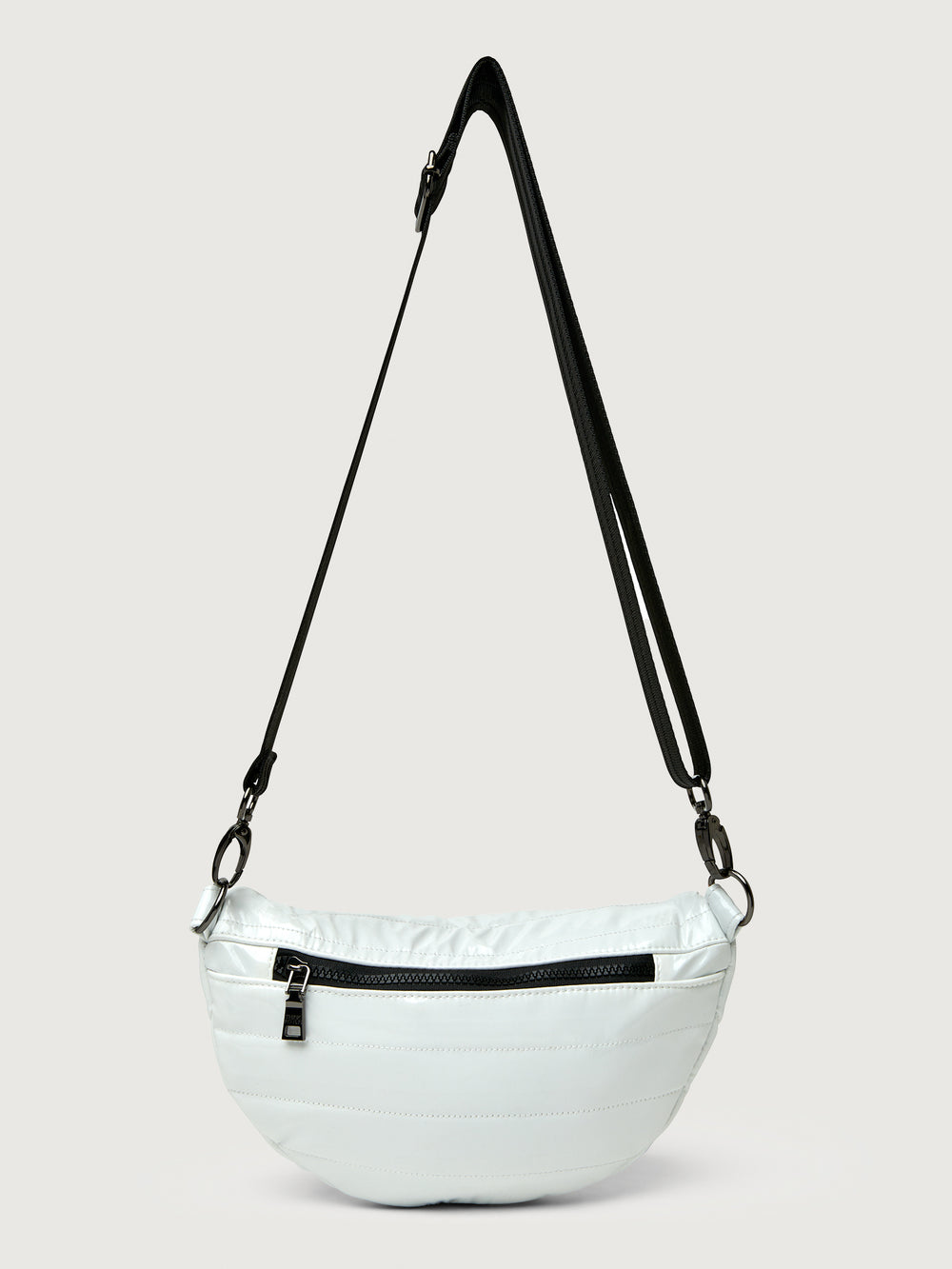 White patent leather bag with black hardware, featuring a half moon shape.