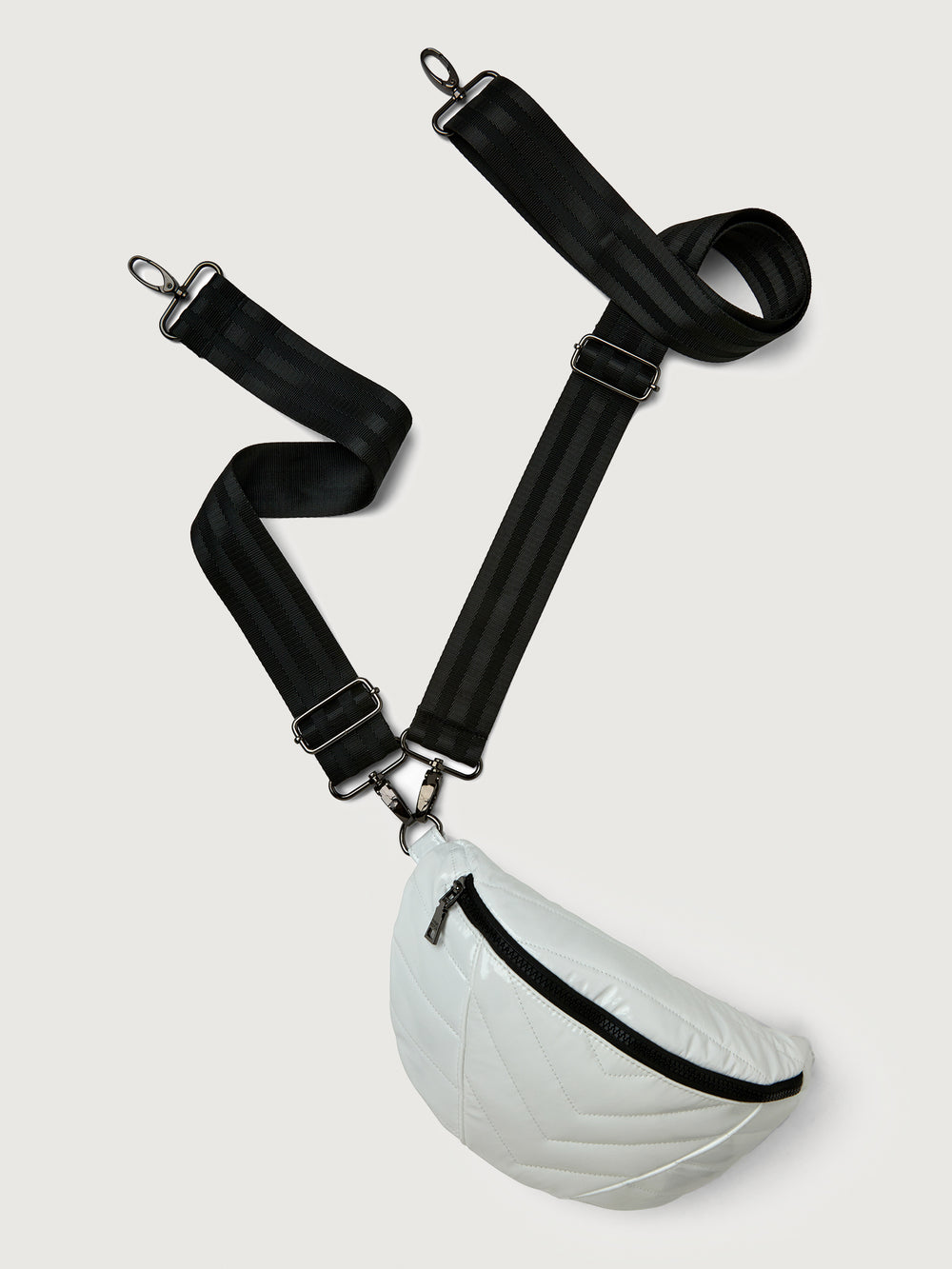 White patent leather bag with black hardware, featuring a half moon shape.