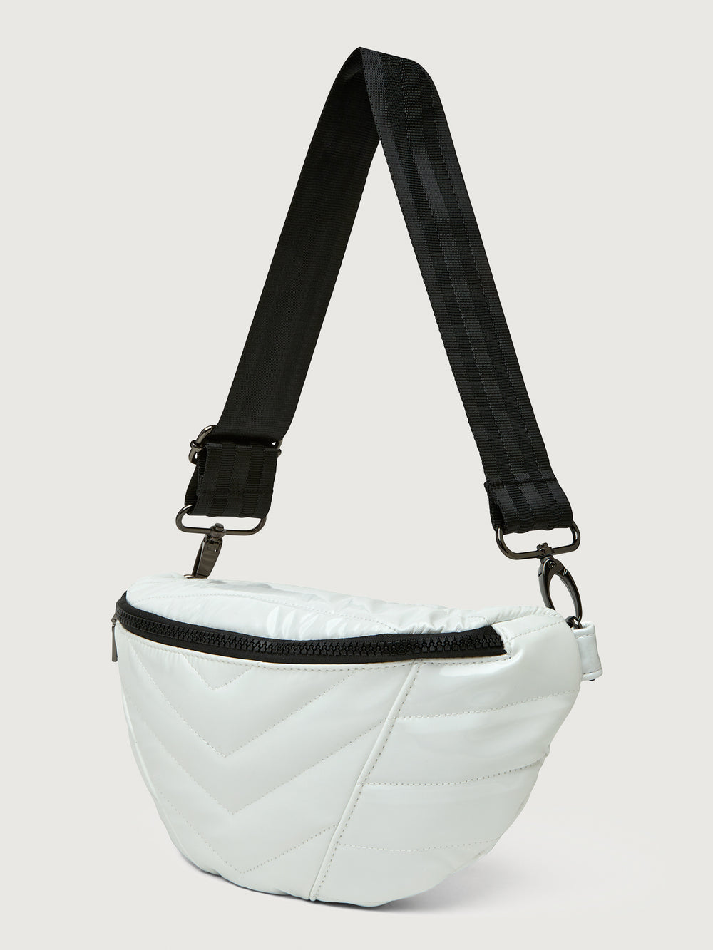 White patent leather bag with black hardware, featuring a half moon shape.